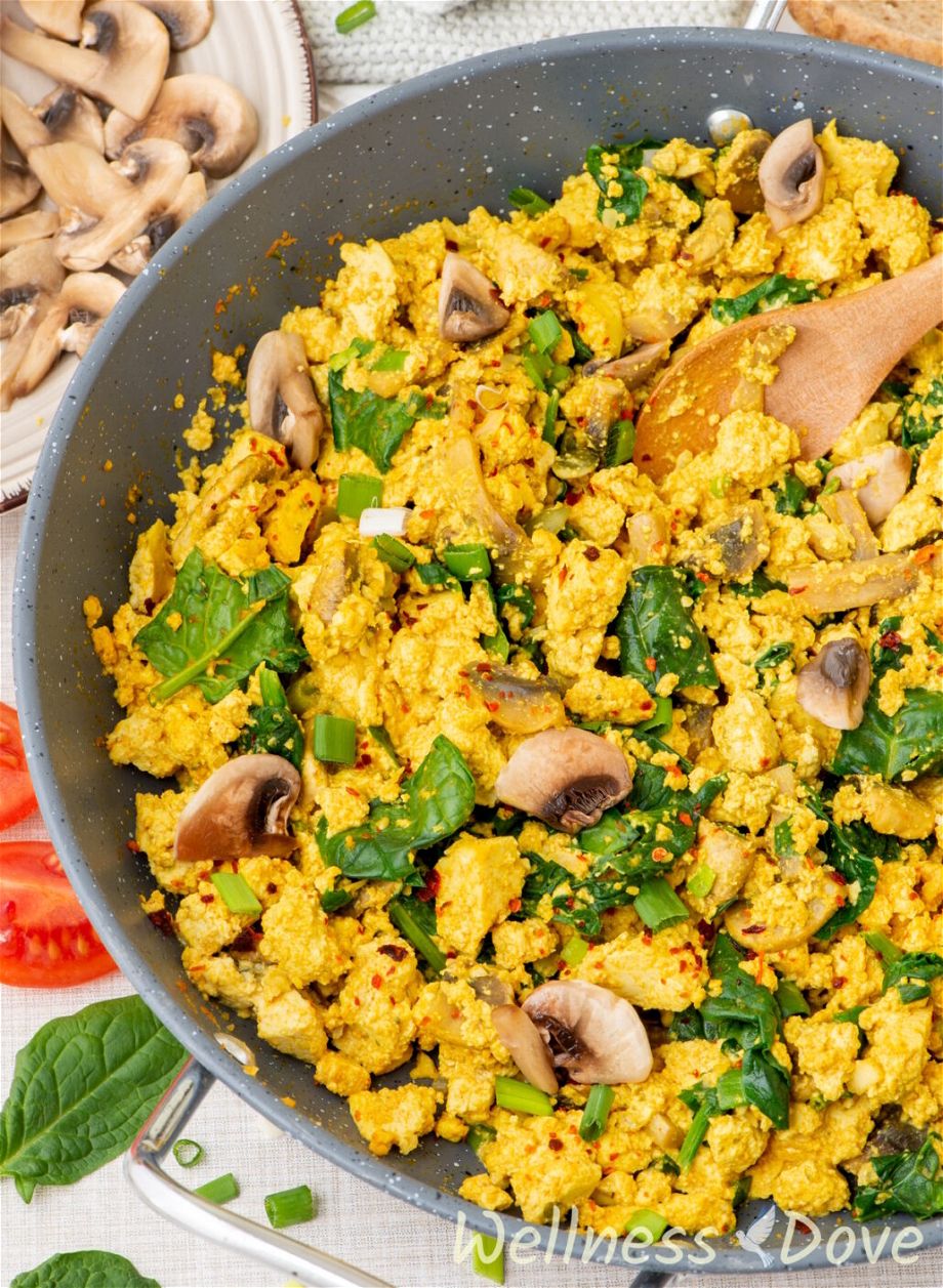 a 3/4 view of the https://wellnessdove.com/vegan-tofu--spinach-egg-scramble in a pan