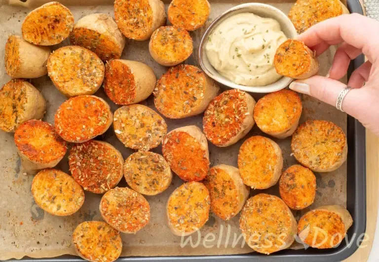 overhead view of the the vegan oven baked potatoes with herbs in a baking tray