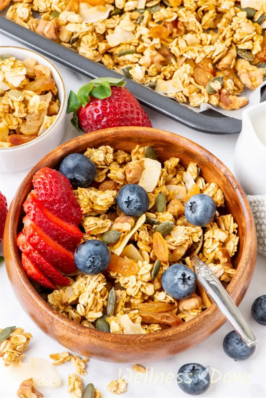 the homemade vegan sugar-free granola recipe  in a wooden bowl from a 3/4 angle