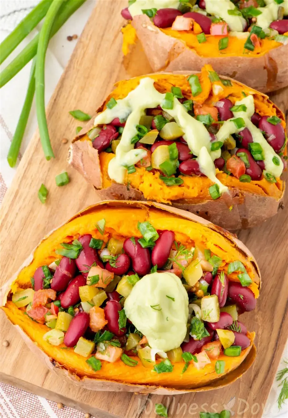 the bean stuffed vegan sweet potatoes  on top of a chopping board