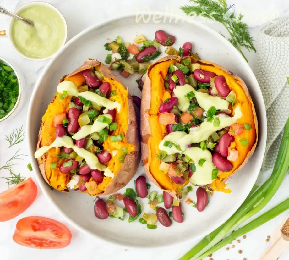 the bean stuffed vegan sweet potatoes  in a large bowl, overhead shot