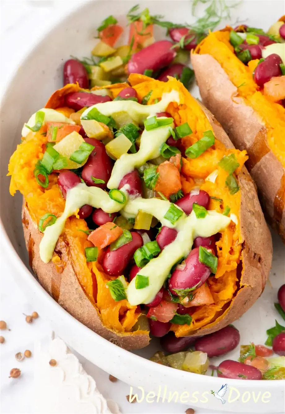 a macro shot of one of the bean stuffed vegan sweet potatoes  in a large bowl