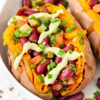 a macro shot of one of the bean stuffed vegan sweet potatoes in a large bowl