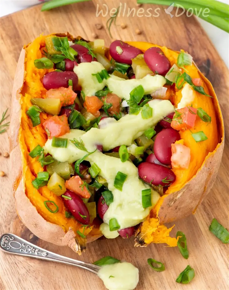 a macro shot of one of the bean stuffed vegan sweet potatoes   on a chopping board