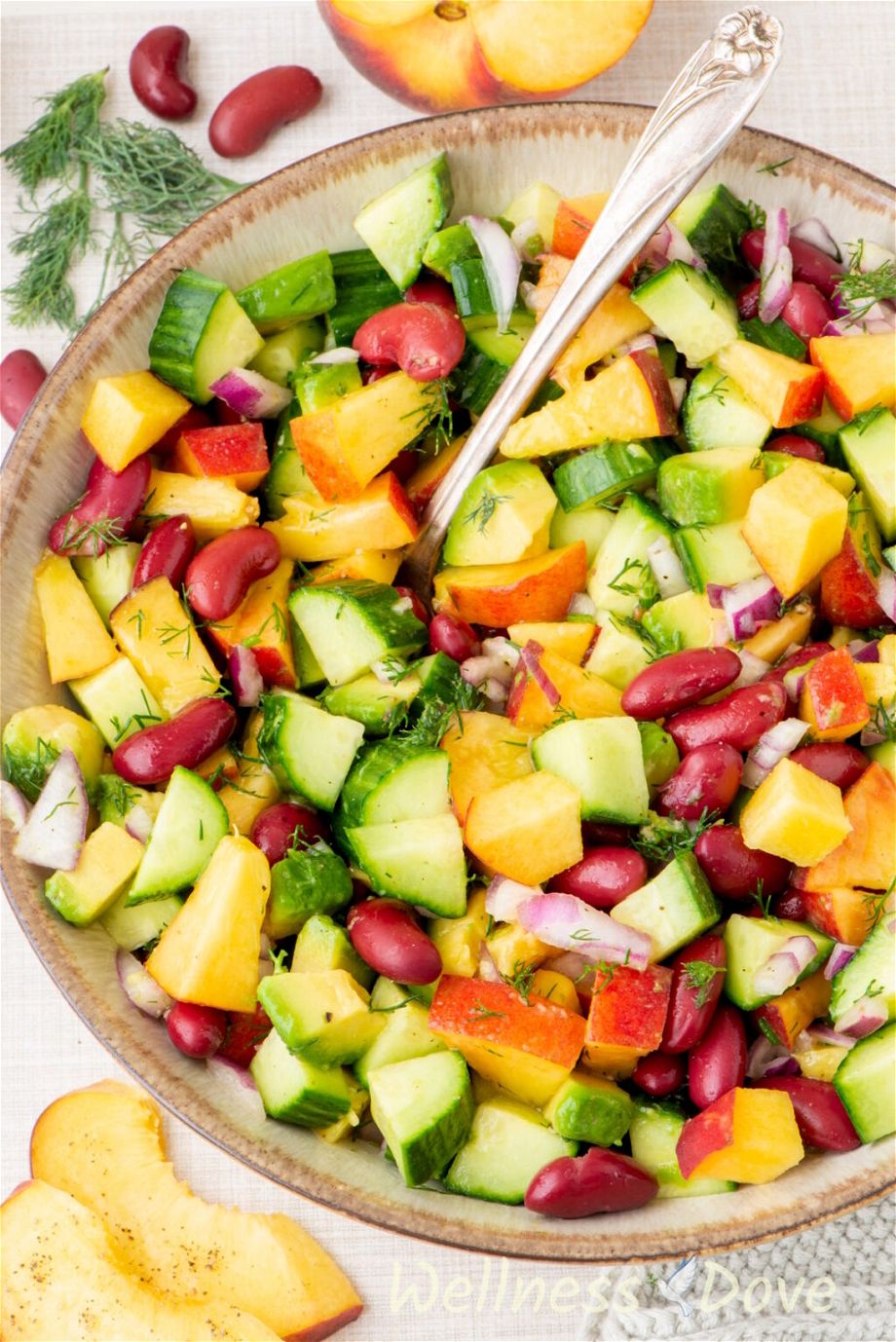 a macro shot of the vegan peach salad with beans in a bowl