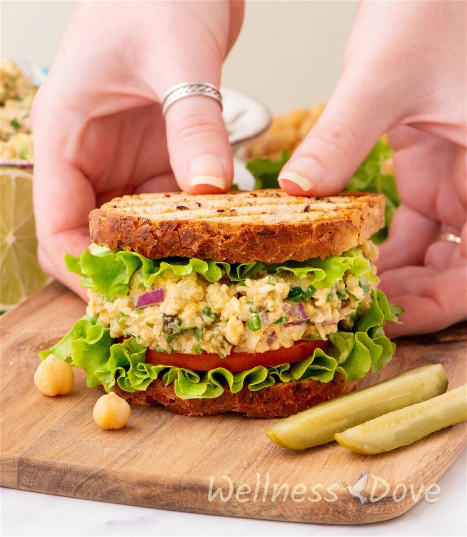 two hands are serving the  Healthy Vegan Chickpea ‘Tuna’ Salad