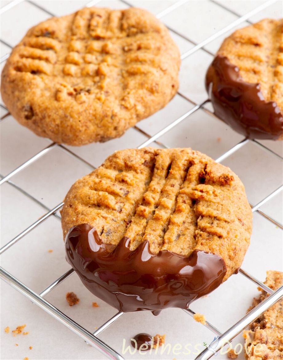 a macro photo of one Easy and Healthy Peanut Butter Vegan Cookie dipped in chocolate